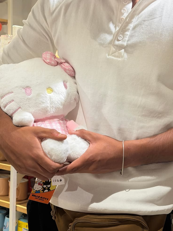 A person holding a Hello Kitty plush gift